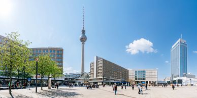 Berlin Alexanderplatz with the TV tower and bustling square on a sunny day.