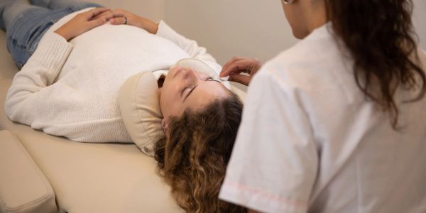 Woman receiving treatment while lying down.
