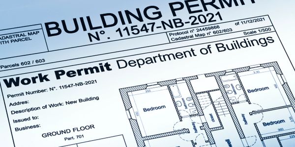 Close-up of a building permit document with floor plan details.