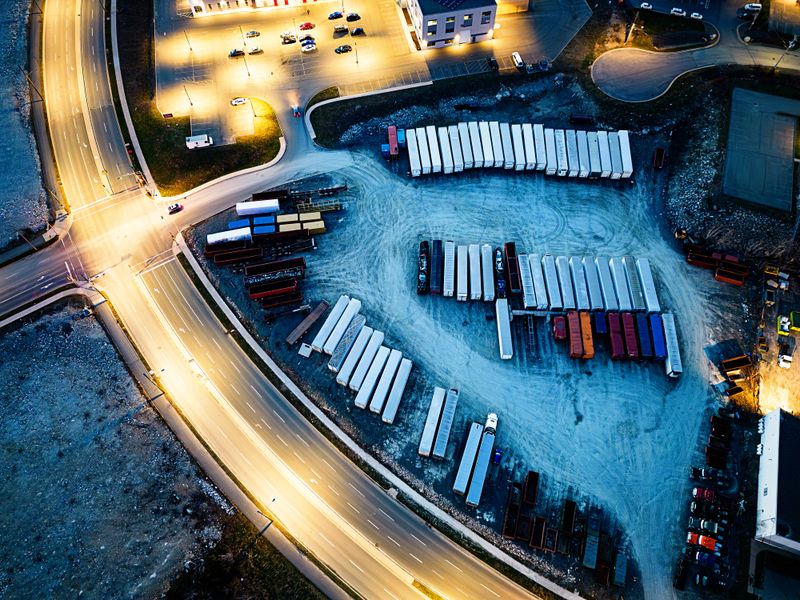 Aerial view of a trucking yard at night.