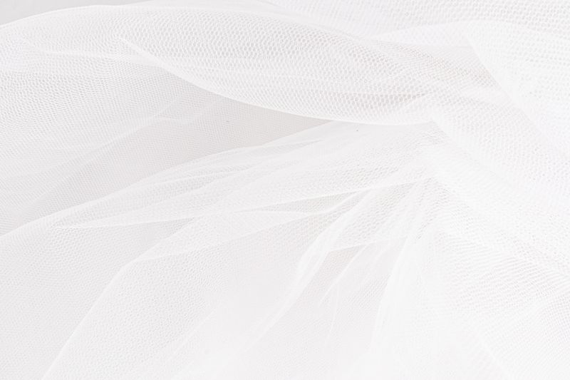 Delicate texture of the background. Elegant soft tulle fabric. Bridal wedding foil close-up for design, plase for text