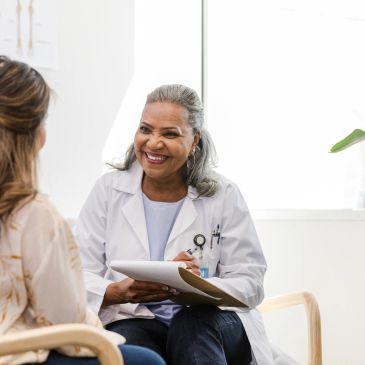 Doctor smiling and talking to patient.