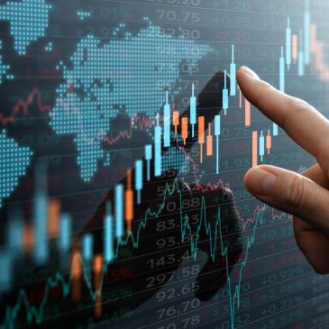 Hand interacting with digital financial charts and global map.