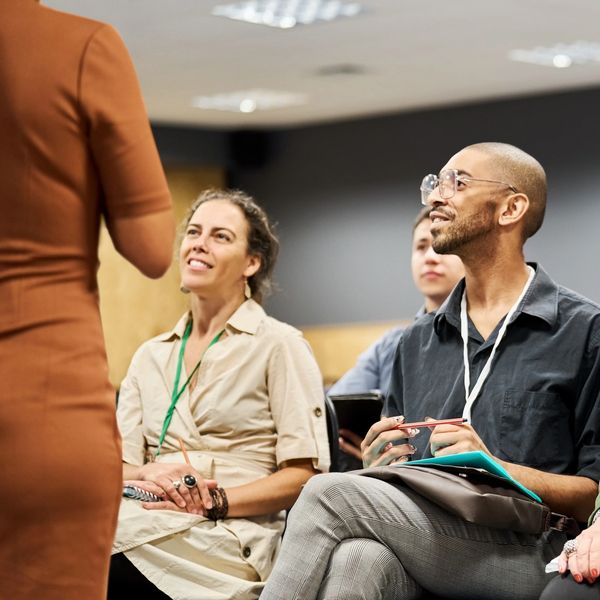 People attentively listening in a seminar or workshop setting.