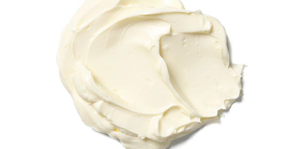 A dollop of creamy white spread on a white background.