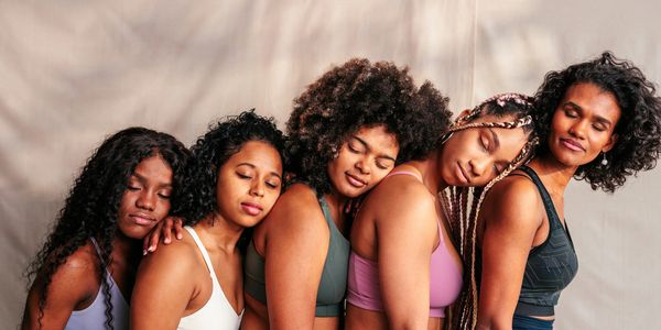 A serene landscape featuring lush greenery, a calm lake, and a clear blue sky.