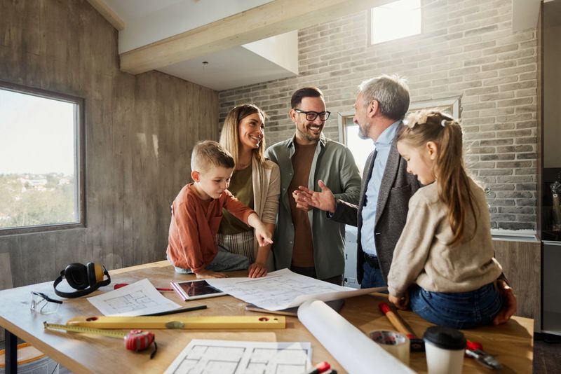 Happy family communicating with their interior designer during home renovation process.