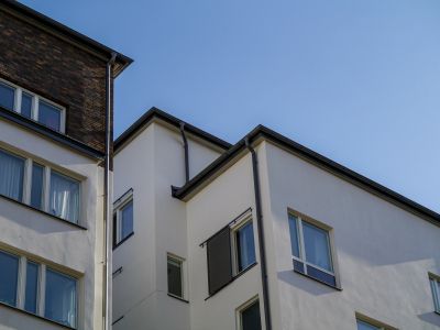 White building with rectangular windows under clear sky.