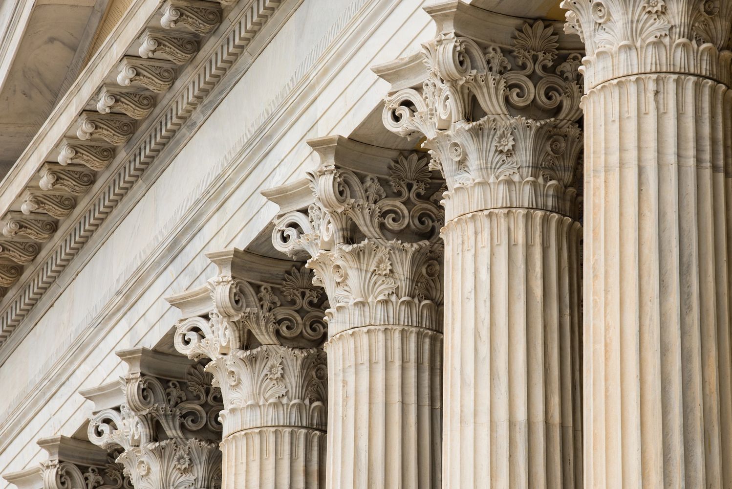 Close-up of ornate Corinthian columns on a classical building.