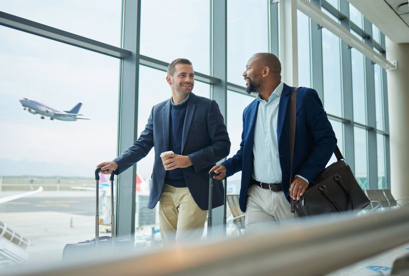 Travel for business, team at airport and men, catch flight for work trip with conference or training seminar with accountant. Walk, talk and diversity with finance convention and partnership