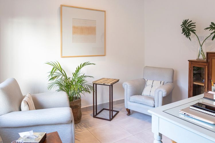 Stack of books next to pencils in a holder and a camera.