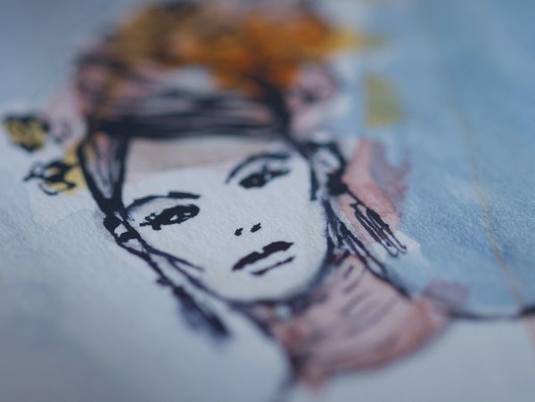 Close-up of a watercolor sketch of a woman's face.
