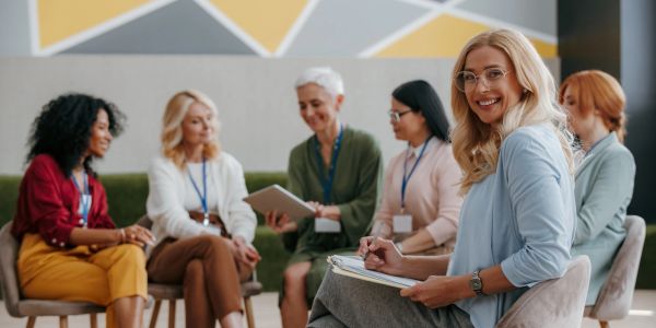 Group therapy session with smiling women.