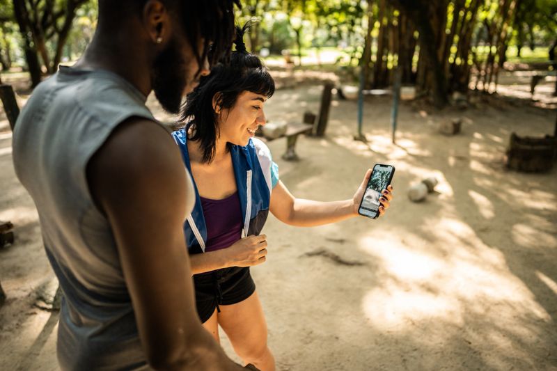 Friends watching sports training in the park