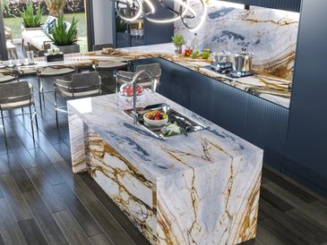Modern kitchen with elegant marble countertops and stylish lighting.