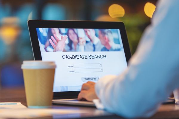 Person searching for candidates on a laptop.