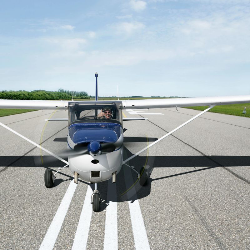 propeller airplane taking off on runway with pilot giving 'thumbs up' gesture, square frame (XXXL)