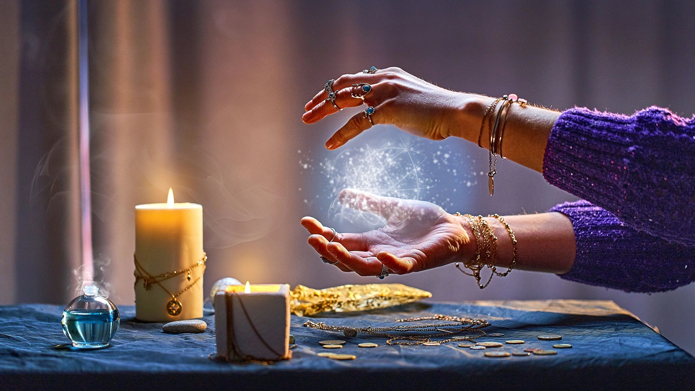 Hands performing a magical ritual with glowing energy and candles on a table.