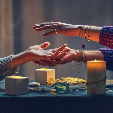 Two hands reaching out in a mystical setting.