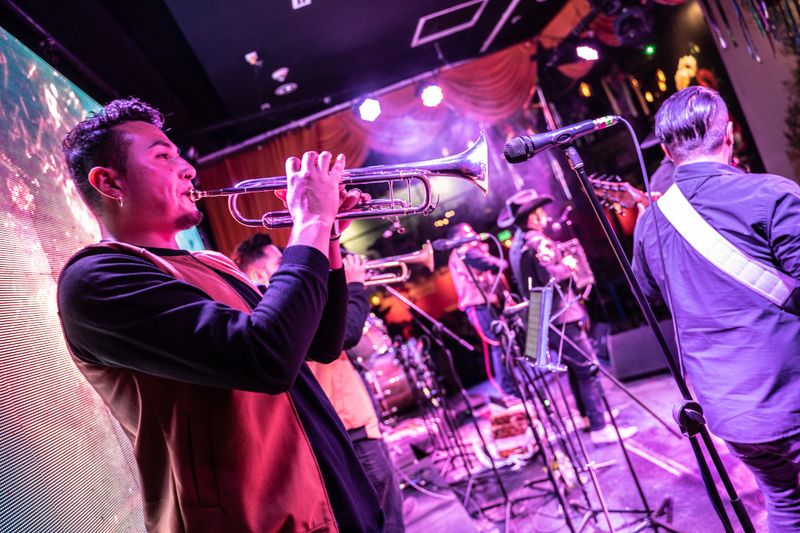 Musician man playing trumpet in a music concert