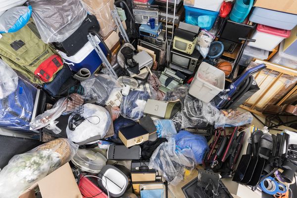 A cluttered storage space filled with various household items.