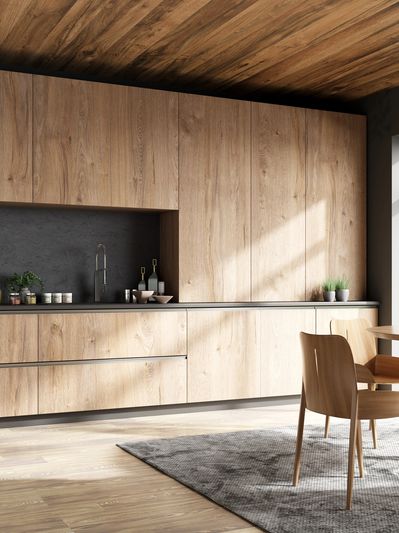 Modern kitchen with wooden cabinets and natural light.