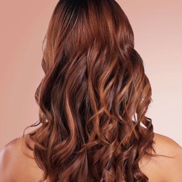 Long, wavy brown hair seen from behind.