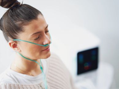 Woman receiving oxygen therapy with nasal cannula.