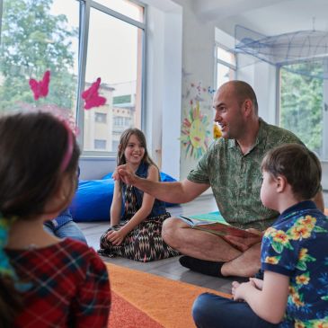 Two teachers reading with young students in a classroom — Special Education Program Assessments serv