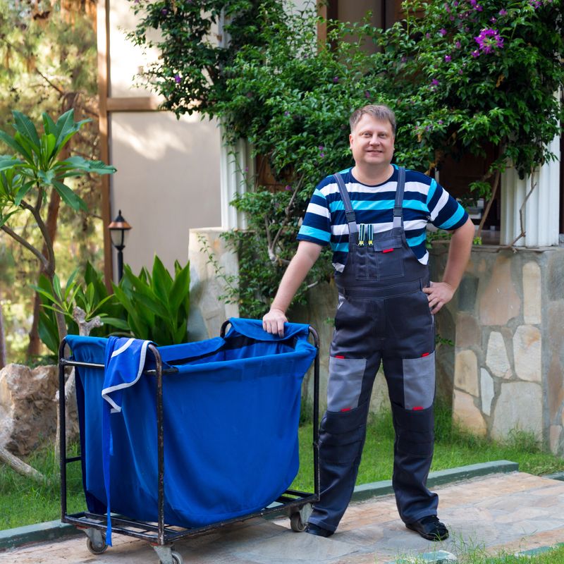 Man picking up linen for laundry a hotel.