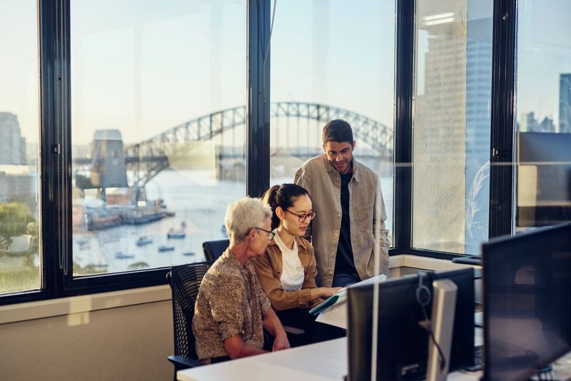 A diverse team of Australian professionals collaborating in a Sydney office.