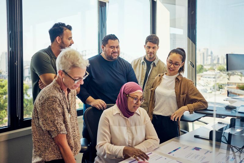 Teamwork and collaboration in a tech-driven Australian office with stunning Sydney views.