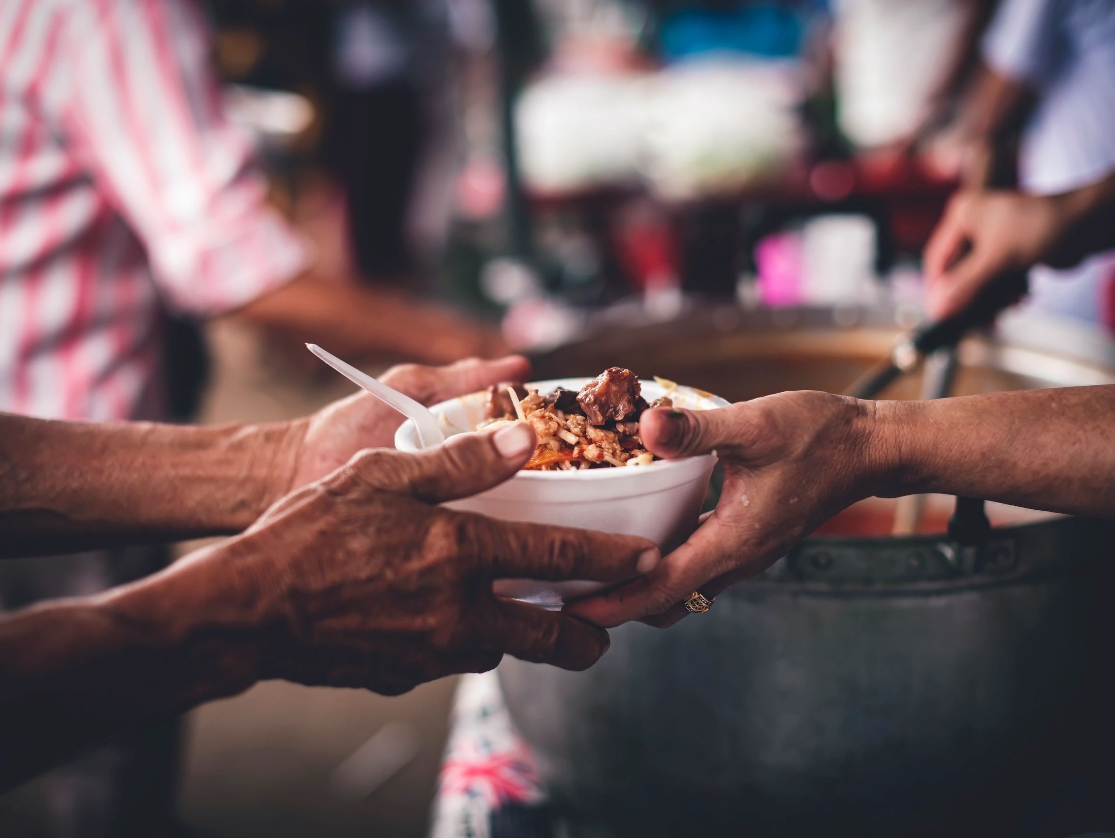 Person serving food to someone in need.