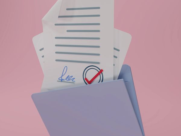 Documents with signature and approval checkmark inside a folder.