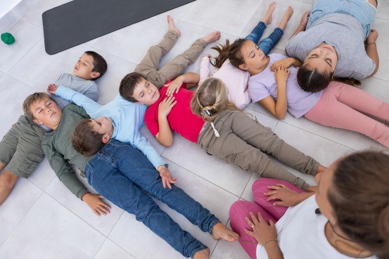 Group of argentinean children between 5 and 12 years-old during meditation, breathing and mindfulness class with yoga teacher - Buenos Aires - Argentina