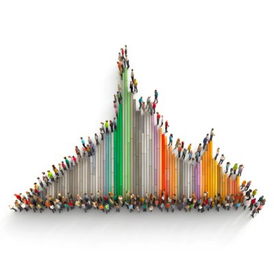 People standing on colorful 3D bar graph blocks forming a population-like chart.