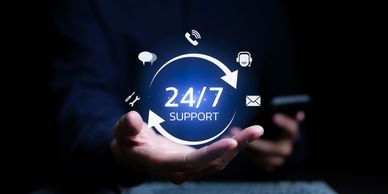 24/7 customer support concept with hand holding digital icons.
