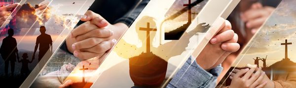A rosary with a cross lies on an open Bible.