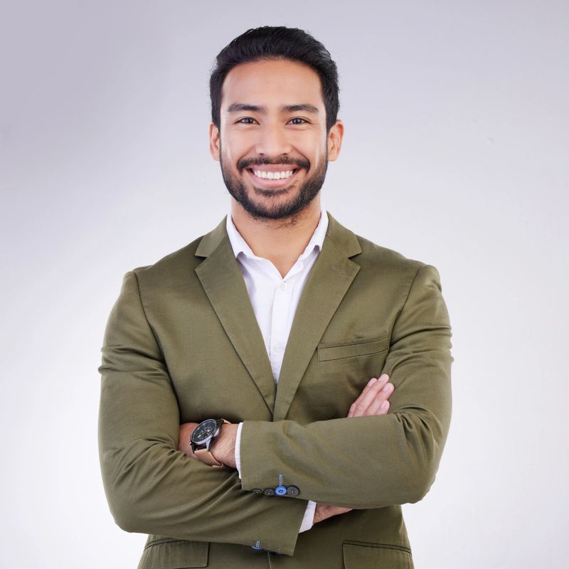 Smile, crossed arms and portrait of business man in studio for success, confidence mindset and leadership. Corporate manager, ceo and happy face of male on white background in professional clothes