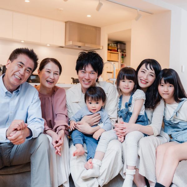 A happy multi-generational family sitting together on a couch.