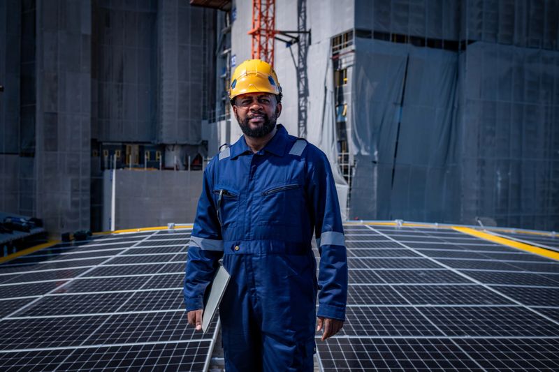 Engineers walking on roof inspect check and maintenance solar cell panel by hold equipment and cordless drill ,solar cell is smart grid ecology energy sunlight alternative power factory concept