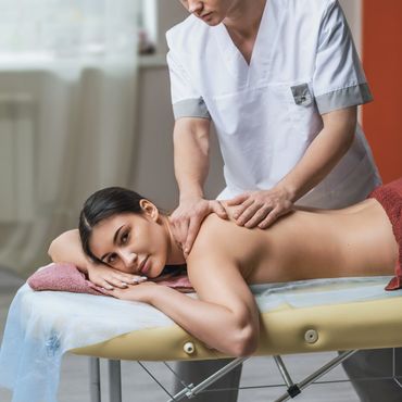 Woman receiving a relaxing back massage from a professional therapist.