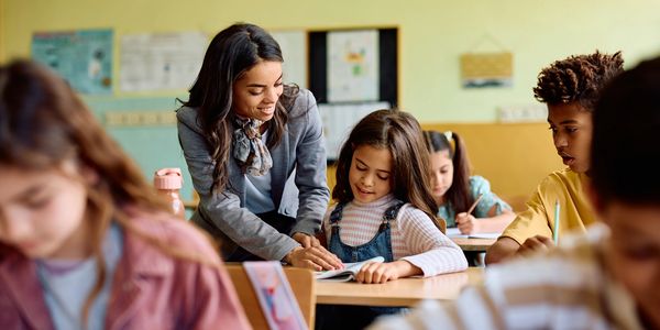 Teacher helping a student in the classroom.