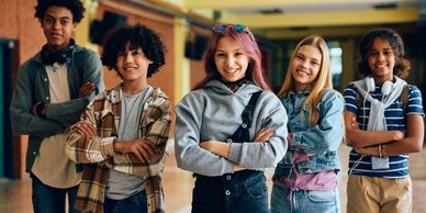 Teenagers standing in a group smiling