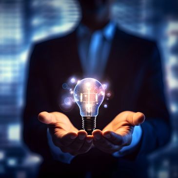 Businessman holding a glowing light bulb symbolizing innovation.