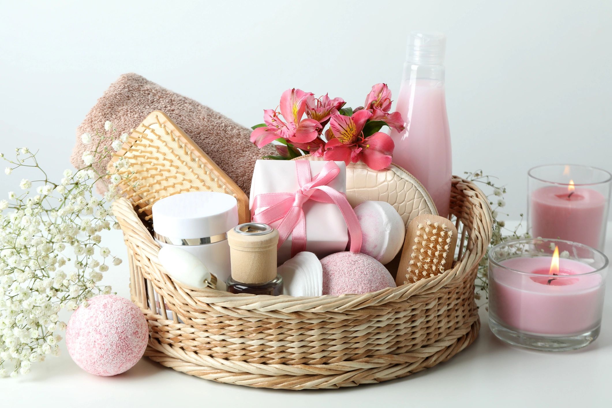 Concept of gift with basket of cosmetics on white table