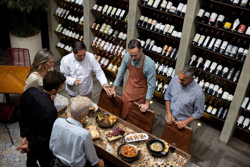 Latin American chef presenting a new menu to his team at a restaurant - small business concepts