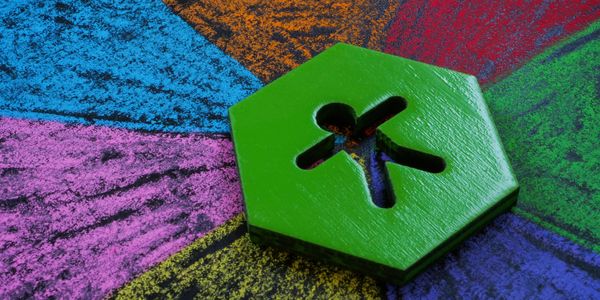 A stick figure on a hexagon with multiple chalk colors branching off