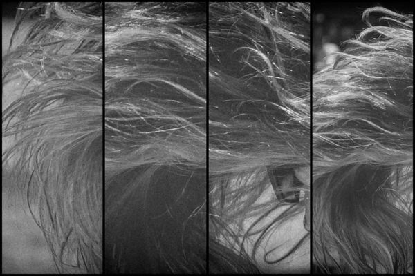 Black and white close-up of hair flowing, divided into four vertical panels.