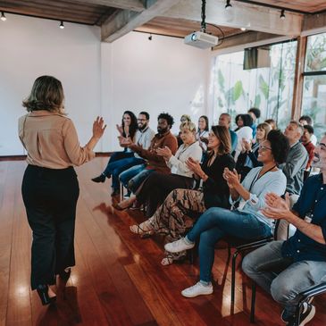 Speaker addressing an engaged audience in a meeting room.